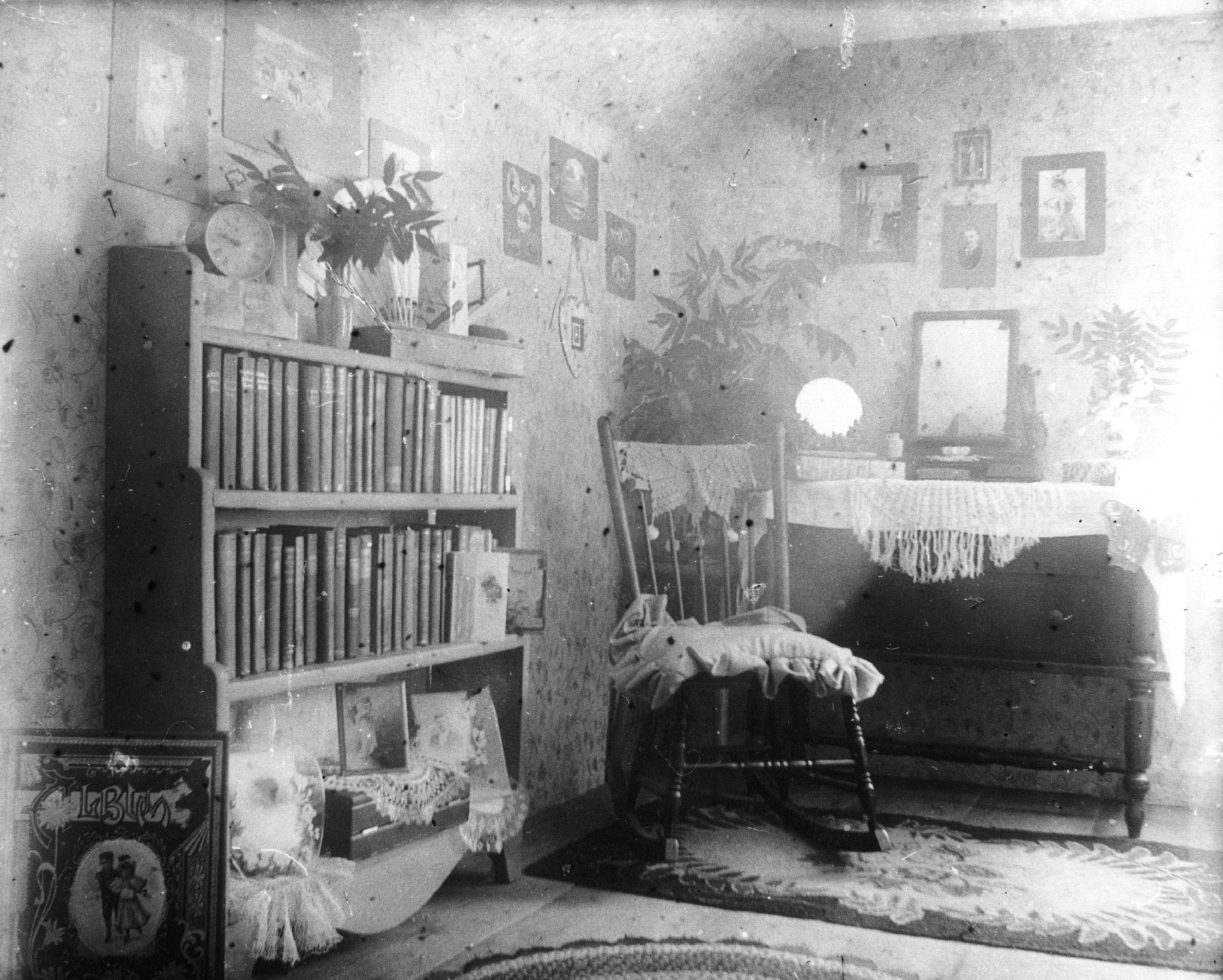 corner of bedroom, prominently featuring her bookcase with one of her scrapbooks in the foreground.