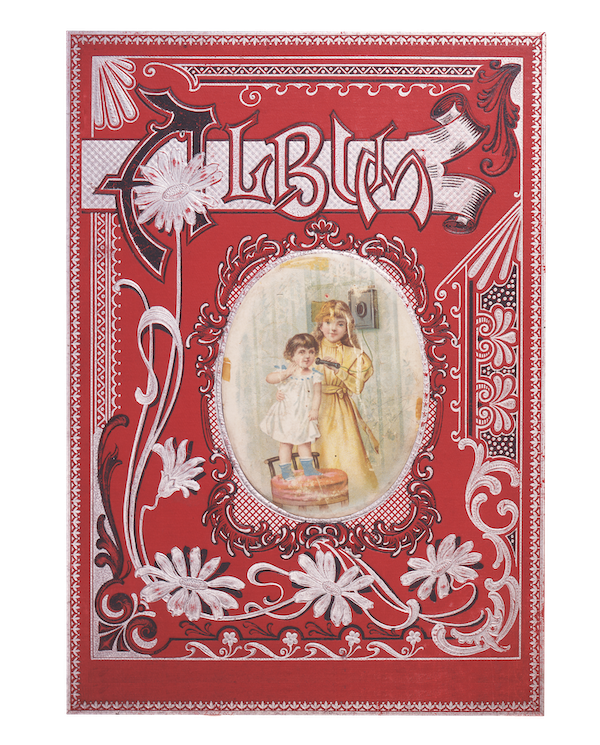 cover of an ornately decorated album with a red background and white and black lettering and a central oval image of two little girls